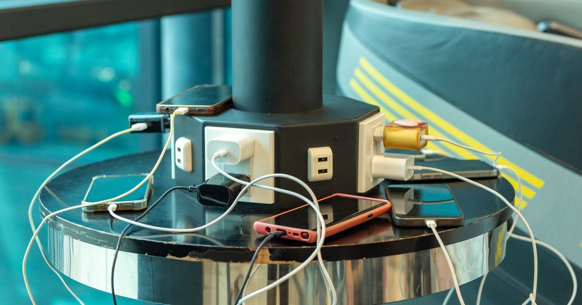 several phones charging at once from a round multi-port charging station